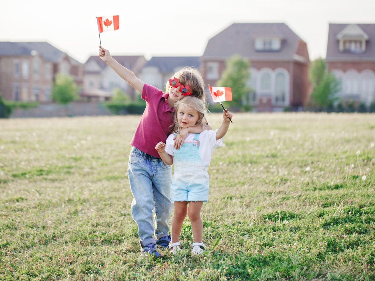 A family wrapped in a Canadian flag